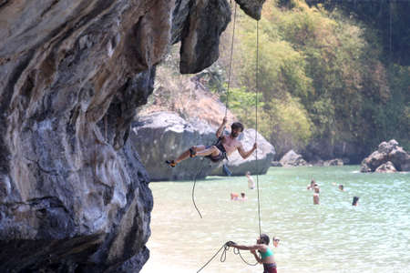 Mountaineers exercise rock climbing at Beach Bay in Krabi, Thailand 03 12 2019のeditorial素材