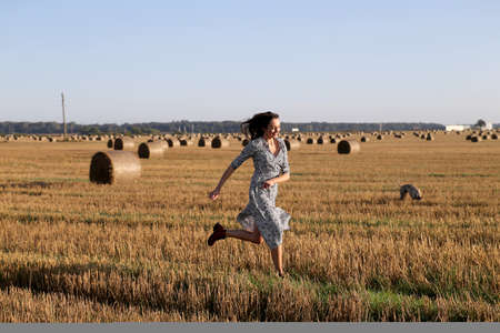 Portrait of a girl in a field with hayの写真素材