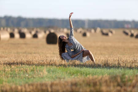 Portrait of a girl in a field with hayの写真素材