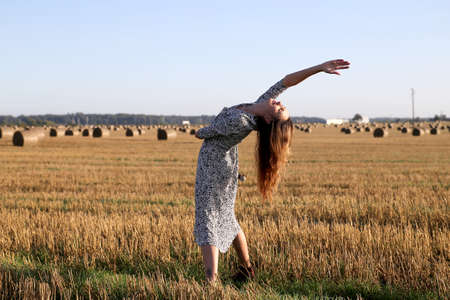 Portrait of a girl in a field with hayの写真素材