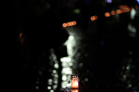 Candle flame with abstract bokeh background during the rain in the city. Vespersの写真素材
