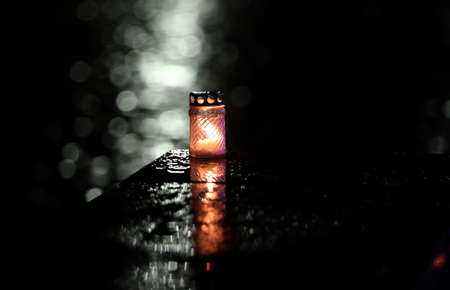 Candle flame with abstract bokeh background during the rain in the city. Vespersの写真素材