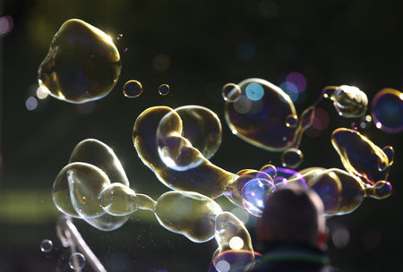 Soap bubbles in nature as a background blurの写真素材