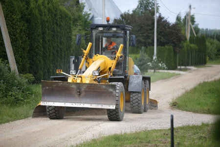 Road grader bulldozer, leveling the settlements on the roadのeditorial素材