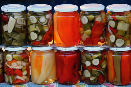 Close up of pickled vegetables in glass jarsの写真素材