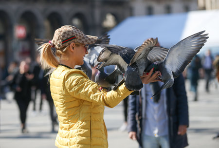 Feeding the pigeons in Milan square, Italy, 04 09 2017のeditorial素材