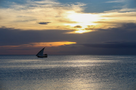 Sunset and boats in the sea, sunset on Zanzibar beach, amazing natural beauty