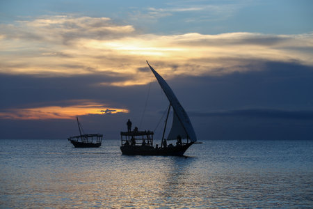 Sunset and boats in the sea, sunset on Zanzibar beach, amazing natural beauty