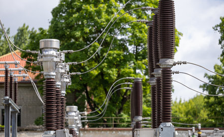 A wooden electricity pole with green insulators