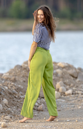 Gorgeous hippie girl model enjoying a summer evening outdoors in a gravel pitの写真素材