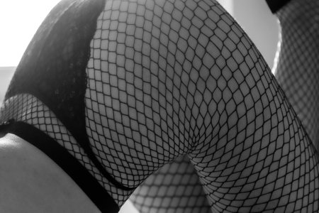 Young woman in pantyhose on bedの写真素材