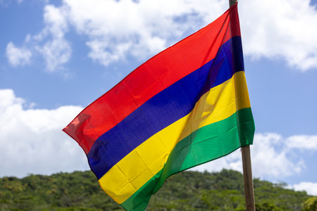 The national flag of Mauritius flutters on the lawn