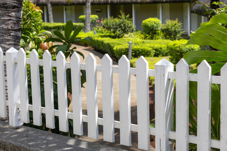 White wooden fence in the garden. Selective focus and small depth of field.の写真素材