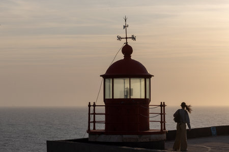 The famous red lighthouse of Nazar, the place further to the west of Europe (Portugal)の写真素材