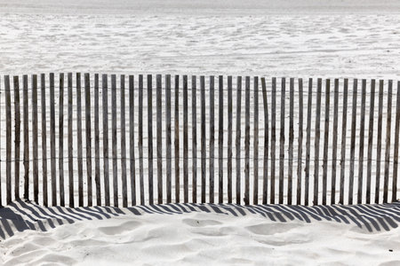 The shadow thrown by a fence on the beachの写真素材