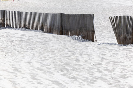 The shadow thrown by a fence on the beachの写真素材