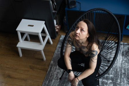 Social photography, portrait of a tattooed girl at homeの写真素材