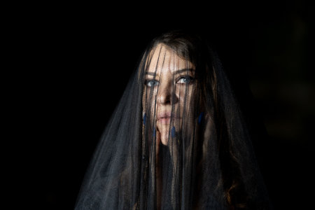 Halloween night woman's portrait: a gaze through the veil of mystery and strengthの写真素材