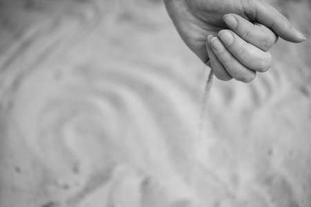Time Slipping Through Fingers in Grains of Sand. A Moment Slipping Along with Streams of Sand