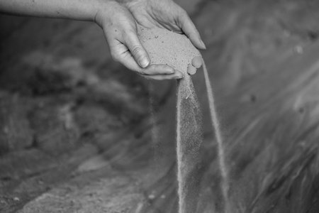Time Slipping Through Fingers in Grains of Sand. A Moment Slipping Along with Streams of Sand