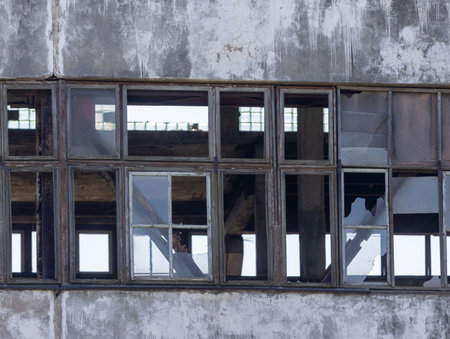 Abandoned industrial building, shattered windows, forgotten by people, an industrial relicの写真素材