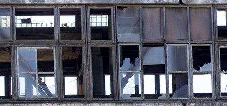 Abandoned industrial building, shattered windows, forgotten by people, an industrial relic