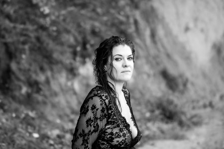 Wet Curls and the Elegance of Black Lace: A Portrait of a Woman's Gaze and Characterの写真素材