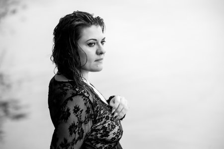 Wet Curls and the Elegance of Black Lace: A Portrait of a Woman's Gaze and Characterの写真素材