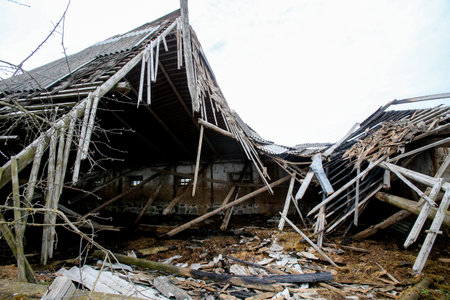Collapsed old abandoned farm building after a fire