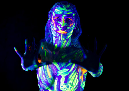 Glowing Body Art in the Dark: Fluorescent Paint and Studio Lightingの写真素材