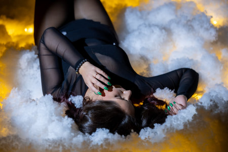 Artistic Portrait in Cloudlight: A Beautiful Woman Posing in the Studioの写真素材