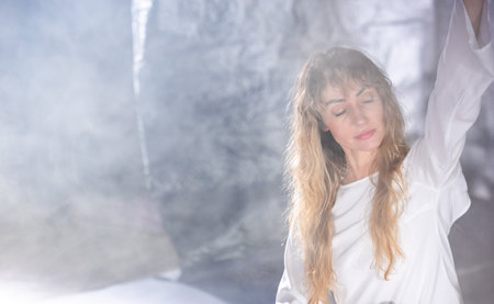 Dance, Painting, and Creative Expression â A Young Beautiful Woman Posing in a Photo Studio"の写真素材