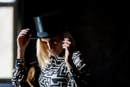 Portrait of a blonde woman with a top hat, interplay of light and shadows