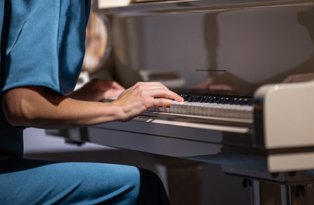 Female hands and white pianoforte keysの写真素材