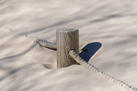 A rope marked seaside path in the sand dunesの写真素材