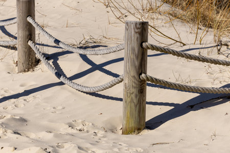A rope marked seaside path in the sand dunes