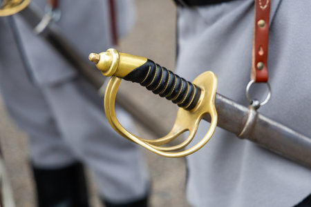 Close-up of historical sword hilt and scabbard in military uniform"の写真素材