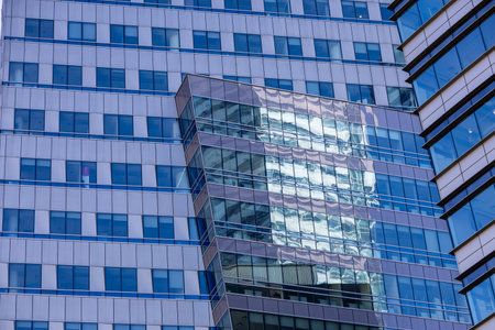 Modern glass architecture and window reflections in Warsaw