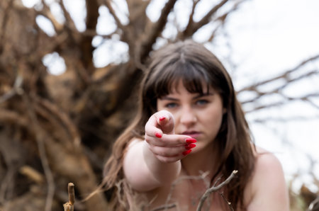 Powerful Nature Portrait of a Young Woman Reaching Outの写真素材