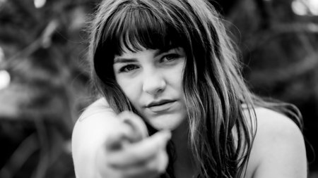 Powerful Nature Portrait of a Young Woman Reaching Outの写真素材