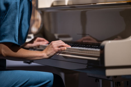 Female hands and white pianoforte keysの写真素材