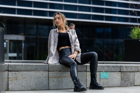 Beautiful Woman Posing in Leather Pants, Modern Style in City Geometry