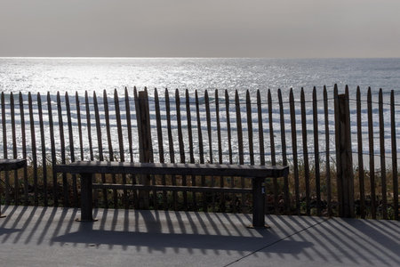 A rustic wooden sand fence along the beach in Lacanau, France, protecting sand dunes from erosion....