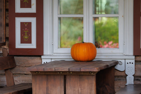 Colorful autumn decorations with pumpkins, flowers and seasonal plants in a cozy countryside garden. Natural fall composition symbolizing harvest, warmth and festive mood.の写真素材