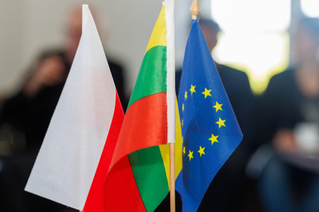 European Union, Lithuanian and Polish miniature flags standing side by side. Symbol of cooperation,...
