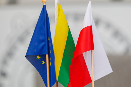 European Union, Lithuanian and Polish miniature flags standing side by side. Symbol of cooperation,...