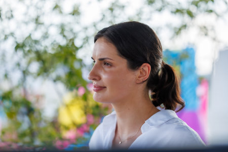 Confident young woman smiling in natural light, representing trust, approachability and positive communication, ideal for business, customer service, marketing and brand identity visualsの写真素材