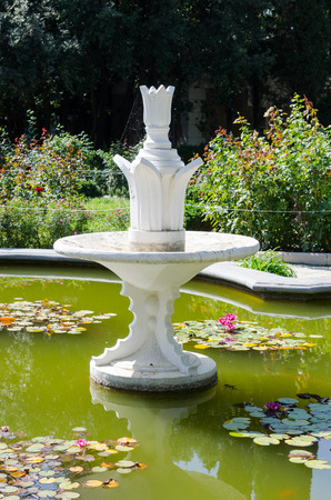 Fountain in the pool with water lilies. Nikita Botanical Garden. Crimea, Yalta, Nikita village.の写真素材