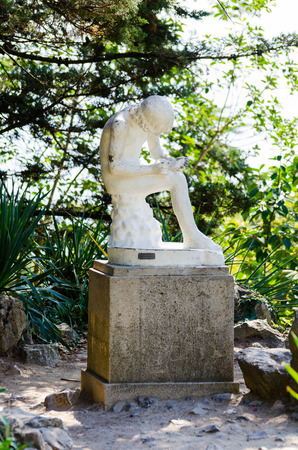Sculpture \"Boy take out a splinter\" Nikitsky Botanical Garden. Crimea, Yalta, Nikita village.の写真素材