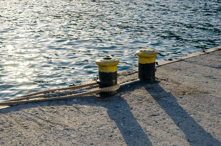 Knecht (double bollard with a common base, which serves for fastening rope) on the pier.の写真素材